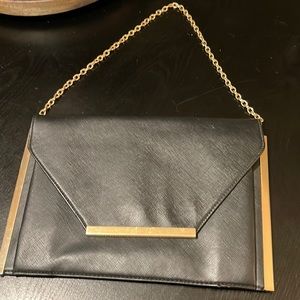 Black textured vinyl shoulder bag with gold hardware